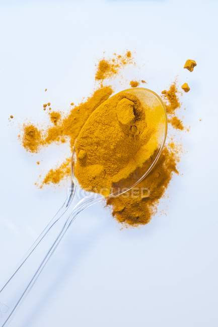 Turmeric powder on spoon, studio shot. — Stock Photo