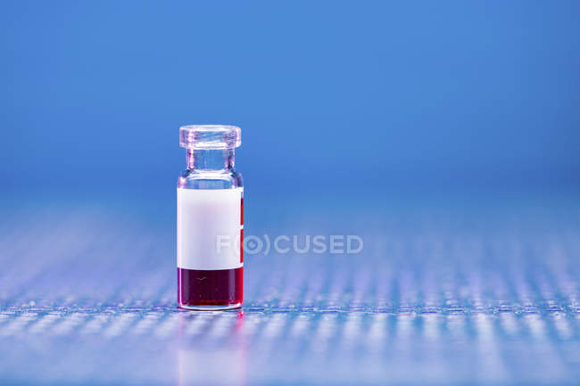 Glass phial with blood sample. — Stock Photo