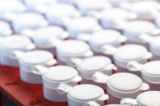 Close-up of rack of microcentrifuge tubes with closed lids. — Stock Photo