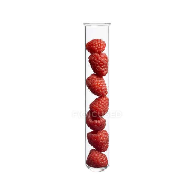 Raspberries in test tube, studio shot. — Stock Photo