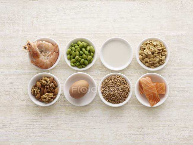 Various allergenic food in bowls, still life. — Stock Photo