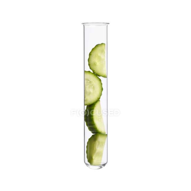 Sliced cucumber in test tube, studio shot. — Stock Photo