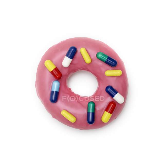 Donut rosa com cápsulas, tiro estúdio
. — Fotografia de Stock