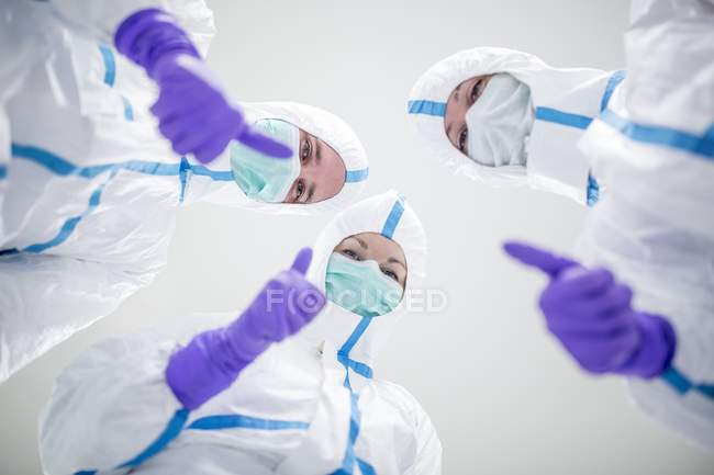 Лаборантів в стерильному середовищі, даючи великі пальці вгору жестом. — стокове фото