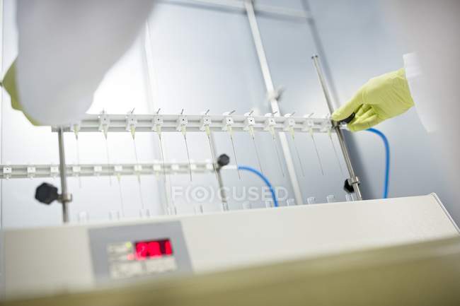 Solid phase extraction columns being placed on stand by technician. — Stock Photo