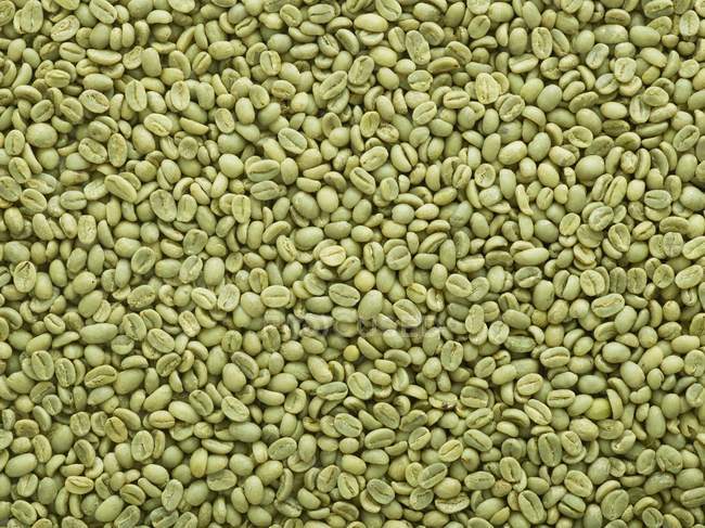Fresh raw green coffee beans, full frame. — Stock Photo