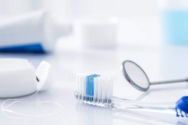 Dental clinic equipment with mirror against white background. — Stock Photo