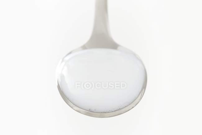 Milk of magnesia on spoon, studio shot. — Stock Photo