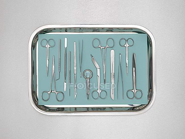 Surgical equipment in tray against white background. — Stock Photo