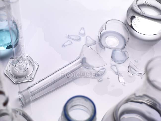 Accident during experiment with broken laboratory glassware flask. — Stock Photo