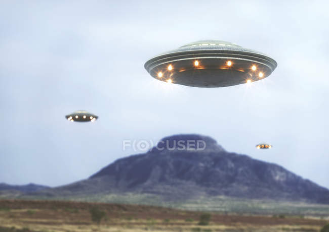 UFOs flying above barren hills, illustration. — Stock Photo