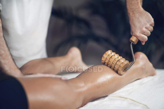 Close-up of woman having anti-cellulite maderotherapy on legs. — Stock Photo