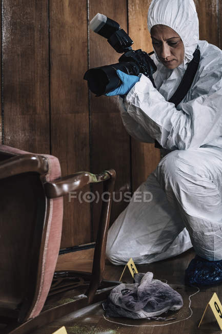 Forensics expert photographing evidence at crime scene. — Stock Photo