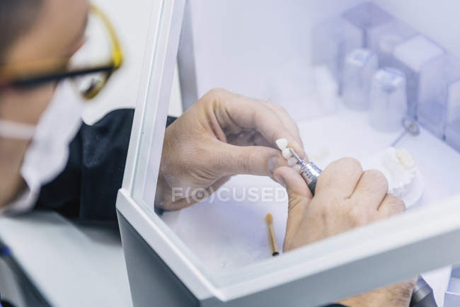 Close-up of male prosthetic dentistry technician at work. — Stock Photo