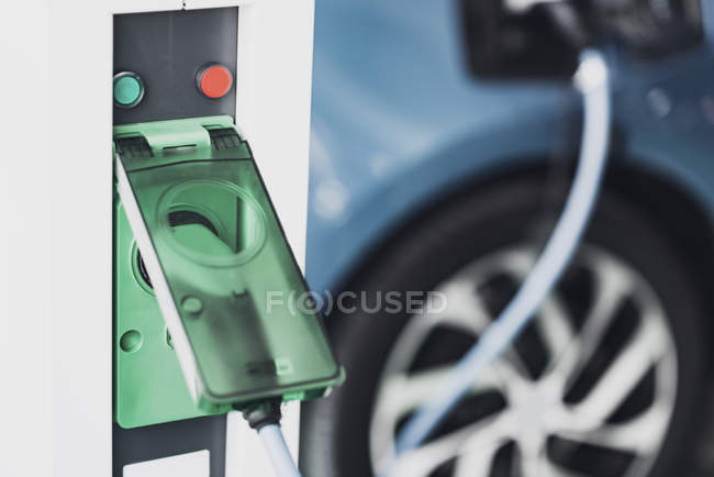 Close-up of electric vehicle charging station device and cable of car. — Stock Photo