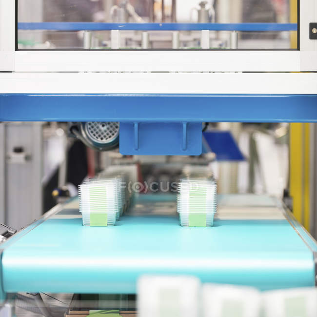 Manufacturing line of plastic containers for food industry. — Stock Photo