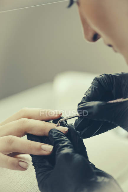 Primer plano de la manicura femenina realizando manicura en el salón . - foto de stock