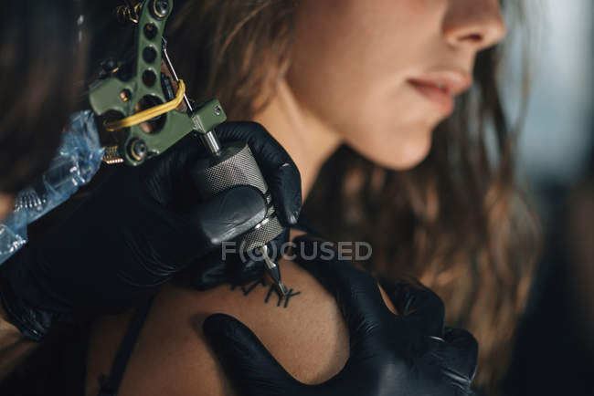 Молода жінка отримує татуювання на плечі . — стокове фото