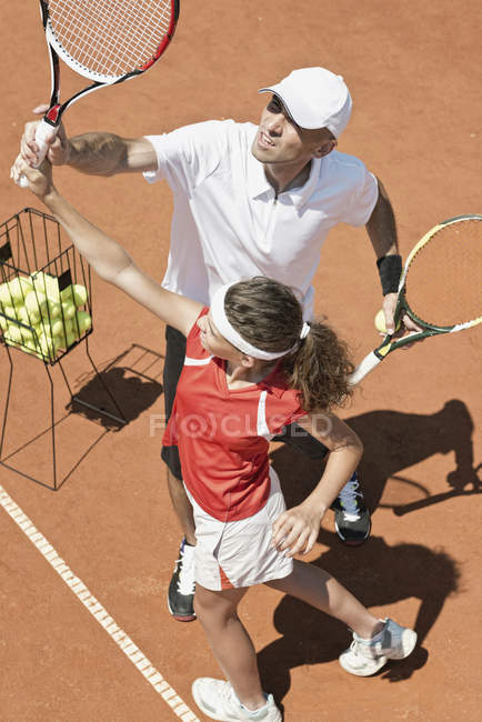 Entrenador con jugador adolescente en clase de tenis
. - foto de stock