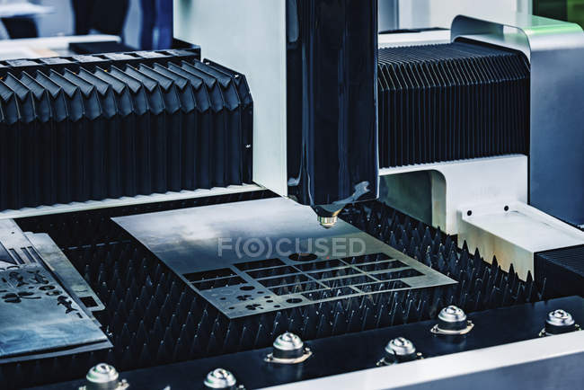 CNC laser head of sheet metal cutting machine in modern industrial facility. — Stock Photo