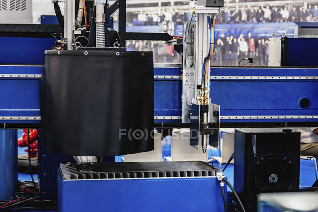 Laser metal machine cutting stainless steel sheet in modern industrial facility. — Stock Photo