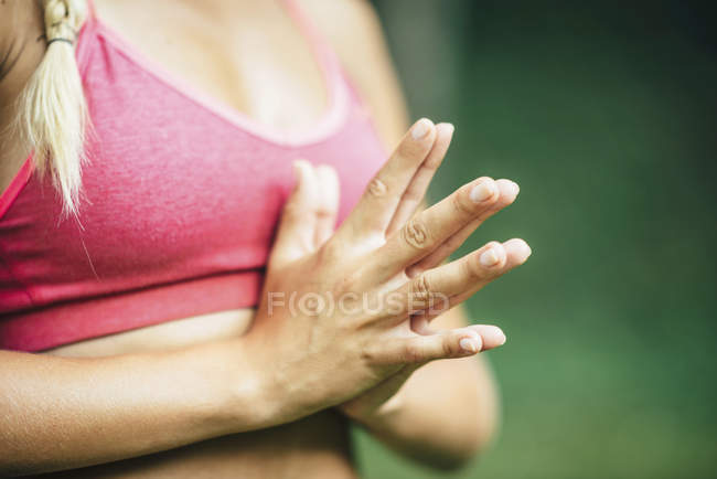 Mujer joven haciendo yoga y meditando, manos en posición de oración . - foto de stock