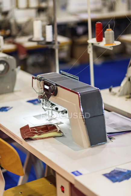 Industrial sewing machine in modern production facility. — Stock Photo