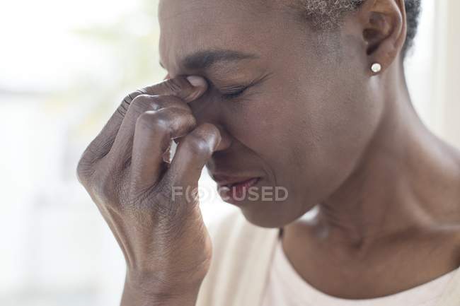 Літня жінка з головний біль напруженості зворушливий міст носа. — стокове фото