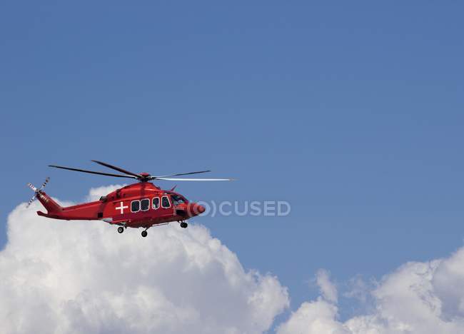 Helicóptero médico en cielo azul con nube . - foto de stock