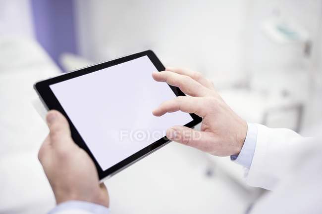 Hands of doctor using digital tablet, close-up. — Stock Photo