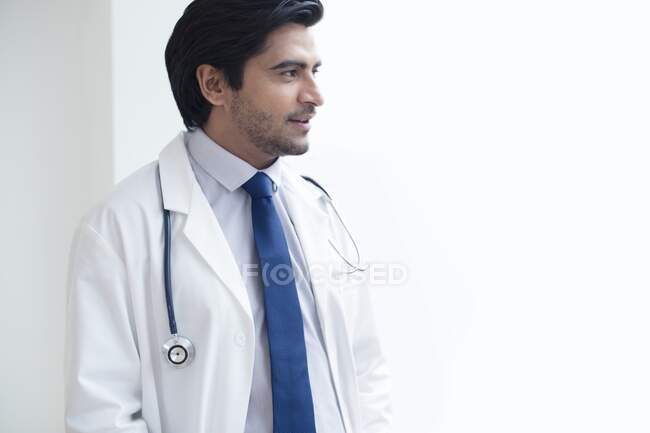 Doctor with stethoscope, looking away. — Stock Photo
