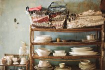 Tableware on wooden shelves — Stock Photo