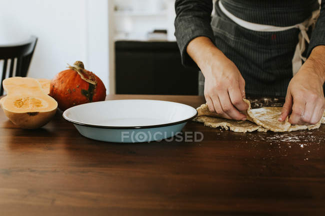 Woman cooking heirloom squash pie — Stock Photo