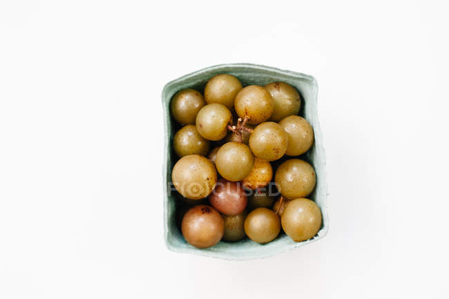 Green grapes in carton box — Stock Photo