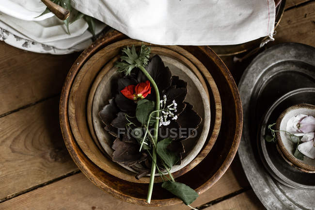 Leaves and petals in bowls — Stock Photo