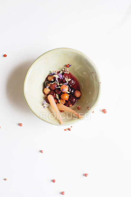 Fruit compote in bowl with lavender flowers — Stock Photo