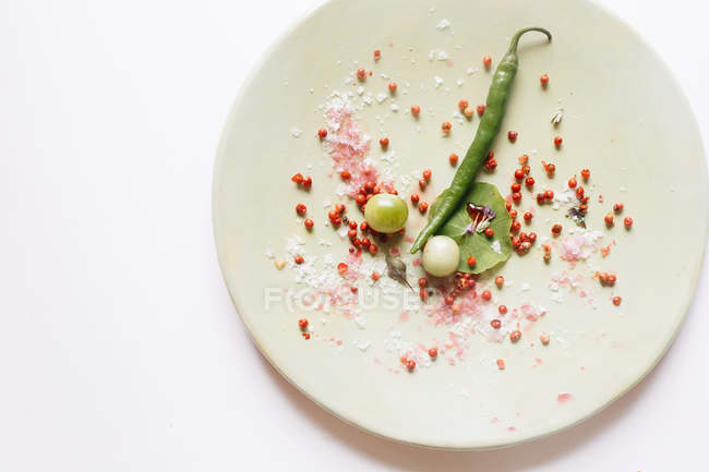 Berries and salt on plate with green bean — Stock Photo