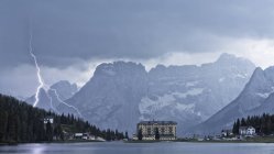 Thunderbolt over Misurina Lake, in background Sorapis mountains, Dolomites, Italy — Stock Photo