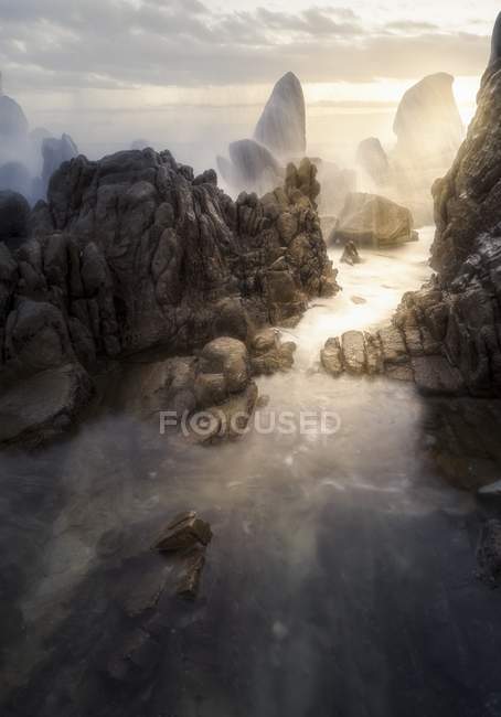 Landschaft mit Wasserwellen und Felsen — Stockfoto