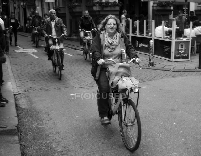 Amsterdam, Netherlands - June 18, 2016: People ridding on bicycles on Amsterdam street — Stock Photo