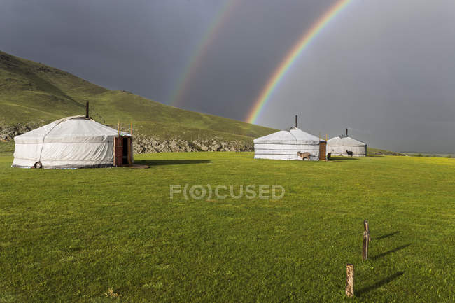 Веселки над типовими монгольськими наметами — стокове фото