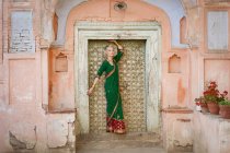 Uma mulher posando em um portão vestindo um sari; Ludhiana, Punjab, Índia — Fotografia de Stock