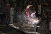 Female welder welding in a shop;Edmonton, alberta, canada — Stock Photo