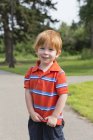 Portrait of young boy with red hair in shirt — Stock Photo