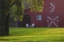 Red Barn With Two Chairs — Stock Photo
