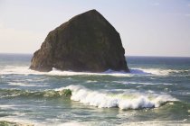 Haystack Rock in sea — Stock Photo