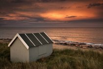 Small Building On Water Edge At Sunset — Stock Photo
