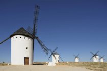 Windmills in a row on field — Stock Photo