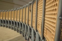 Lot of shopping carts placed in rows at parking — Stock Photo