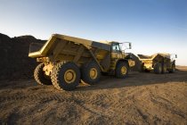 View of trucks Hard At Work over sand — Stock Photo